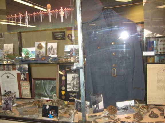 Artifacts of the World War II fighter plane crash are displayed at the Dorothy Henry Library in McAfee.