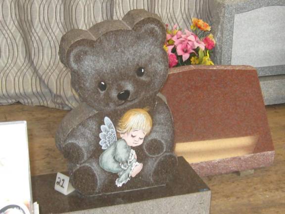 A child’s gravestone shows the artwork that can be accomplished with laser etching.