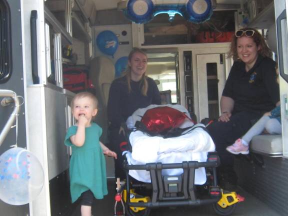 Squad members explain the workings of the ambulance to eager to learn youngsters.