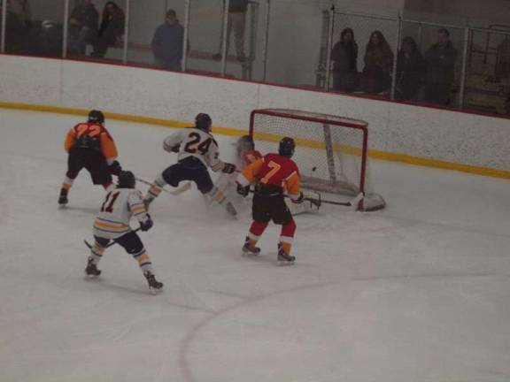 Pope John forward Dylan Kuipers (24) scores in the third period.