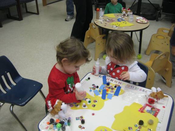 Jackie and Alex decorate bells during the Christmas party.