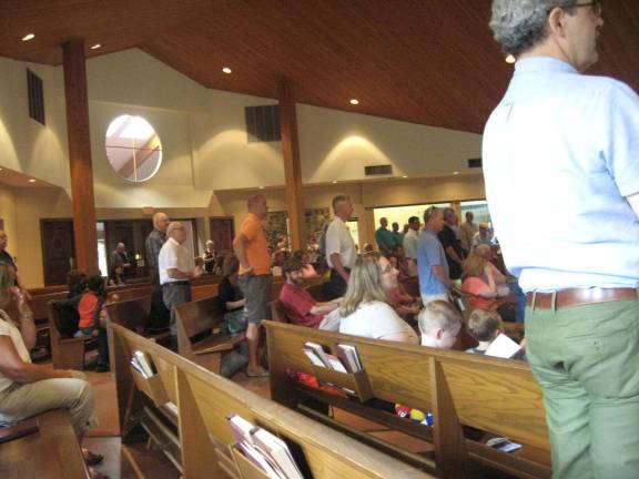 Fathers stand for a special Father&#xfe;&#xc4;&#xf4;s Day blessing at St. Francis de Sales Church.