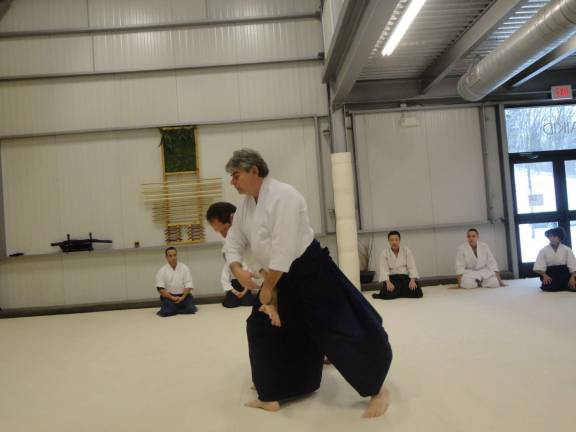 Sensei Greg O'Connor demonstrates a takedown for a class at Sparta's Aikido Center Jan. 25.