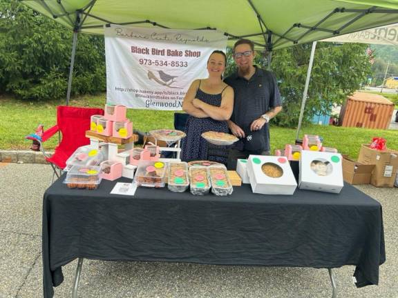 Barbara Centi Reynolds and Jason Reynolds sell items from the Black Bird Bake Shop at the street fair.