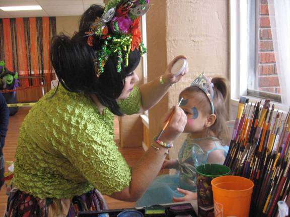 Pixie Pop the Clown face paints Princess Adrianna.