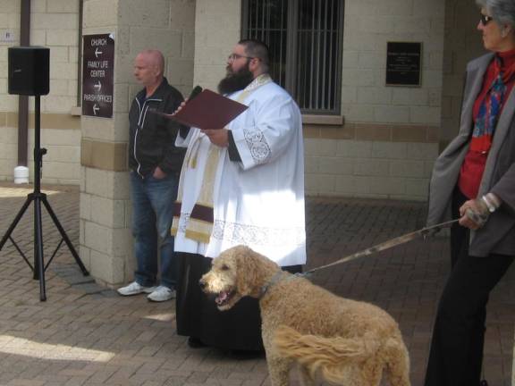 Remembering St. Francis of Assisi, patron saint of animals, Fr. Chris Barkhausen of St. Francis de Sales Church in Vernon, begins the service as Barkley the dog barks along.