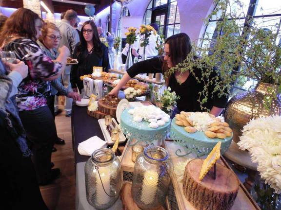 Guests mingle and taste at the fundraiser for Project Self-Sufficiency