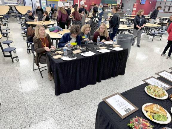 Judges at the Culinary Throwdown taste the meals prepared by four teams of students. From left are From left are Jennifer Pellet, Colin Geisen, Kelly Mitchell and Marge Cobley.