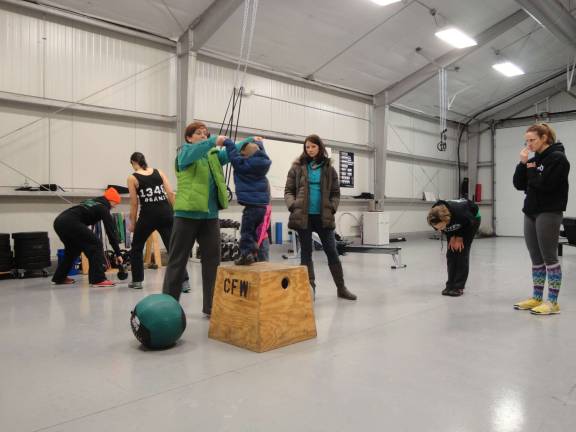Photos by Scott Baker Guests try out the apparatus at Crossfit LMS at the fist-ever open house Jan. 25 in Sparta.