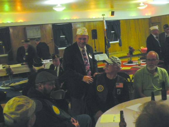 Photo by Scott Baker American Legion State Commander James Amos visits with local post members.