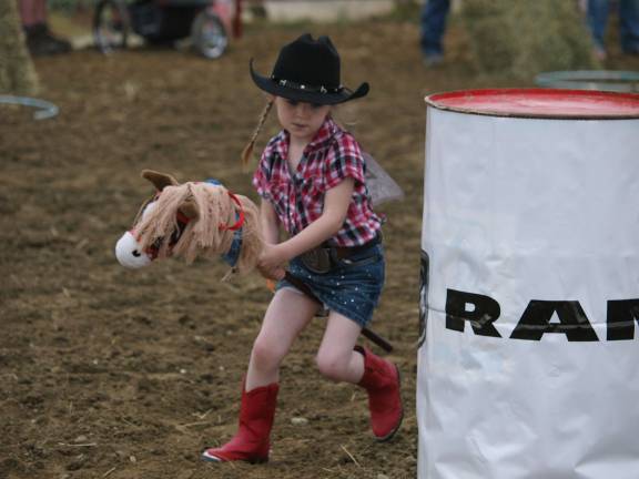 Amelia Murphy (4) of Wantage makes her way along an obstacle course. Murphy won the best dressed cowgirl contest for the second year in a row.