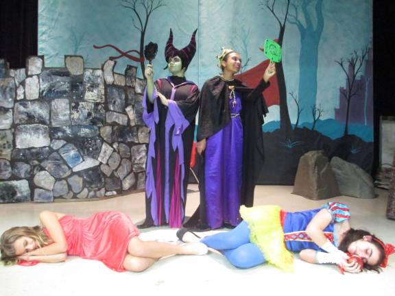 Photo by Viktoria-Leigh Wagner Queen Maleficent, played by Nicole Rodak, and Queen Raveena admire their reflections as Sleeping Beauty and Snow White lie in a deep sleep.
