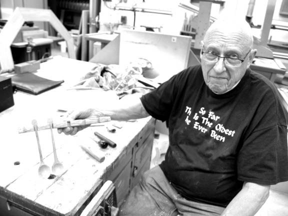 Don Scott of Sparta working on a carved spoon collection.
