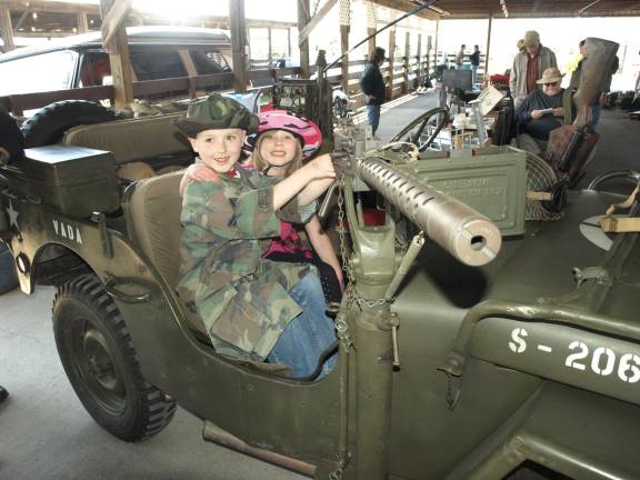 T.J., 8, (left) and Maya, 6, McQueen of Ogdensburg try a jeep mounted machine gun.