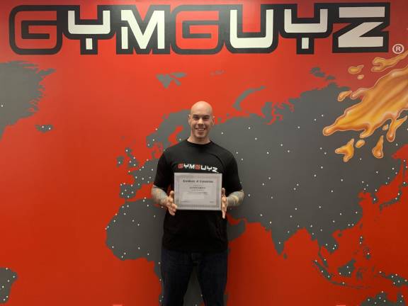 Justin Smith is shown with his GymGuyz certificate of completion.