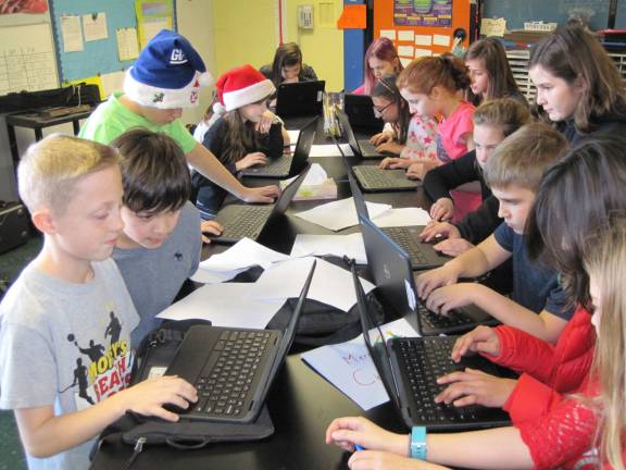 Some of Mr. Griffin and Mrs Lalley's fifth grade students at Lounsberry Hollow School, in Vernon, are in a competition in New Jersey with the Stock Market Game. Students learn about investing in stocks, mutual funds, and bonds. Here a group of students are researching stocks and mutual funds and placing trade orders.
