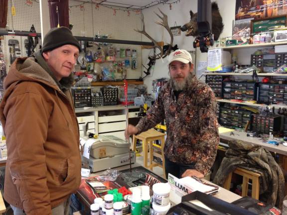 Store owner Mike Bush assists Dennis Sinfield of Highland Lakes with a purchase.