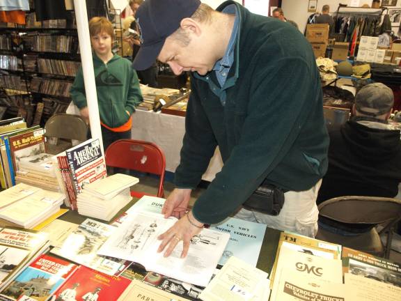 Owner of Portrayal Press, Patrick Tipton of Frankford explaining the level of detail in the maintenance manuals he sells.