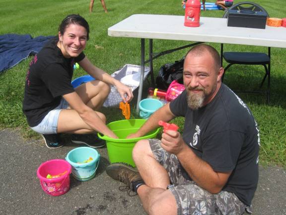 Kayla Turner-Boss and Bob Meyer act as official water gun fillers.