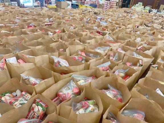 A veritable sea of packed grocery bags ready for distribution