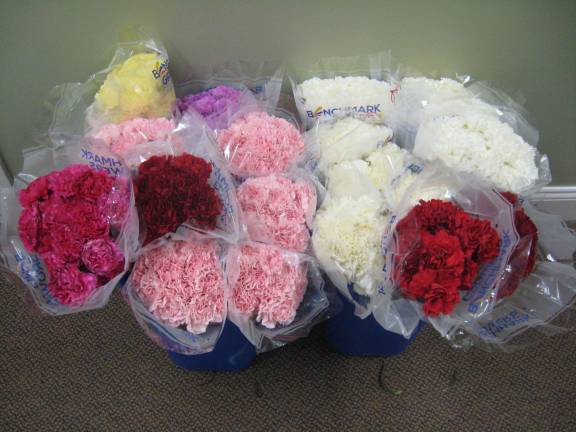 PHOTOS BY JANET REDYKE Carnations await distribution at mass on Mother's Day May 13 at St.Francis de Sales Church