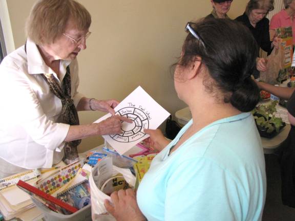 Elsie Lorber assists a Family Expo participant.