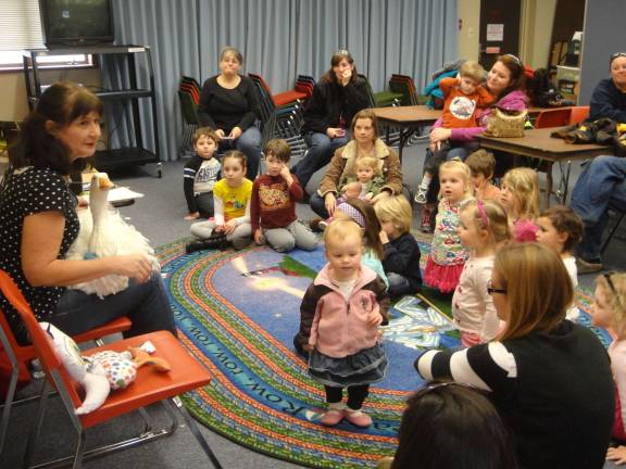 Vernon author talks to children at the Dorothy E. Branch library in Vernon as Oliver, her pet goose, sits in her lap.