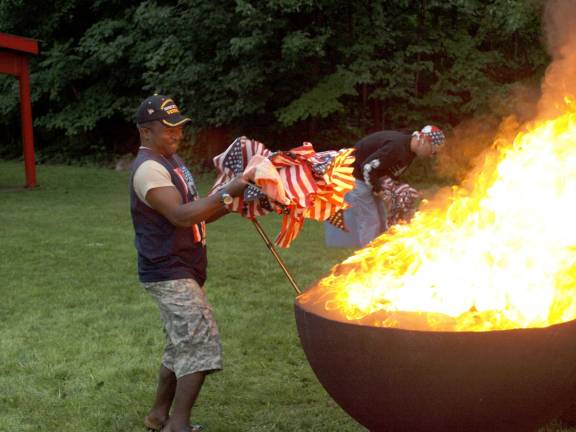 George Alakpa of Hamburg, who served nine years in the Army with 19 months in Afghanistan, lends a hand during the ceremony.