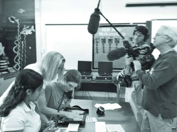 Photos by Laurie Gordon Special Ed Teacher, Tracy Powell, works with students Rena Patel and Ricky Marotta on plans for their dog biscuit project as Classroom Close Up NJ films them.