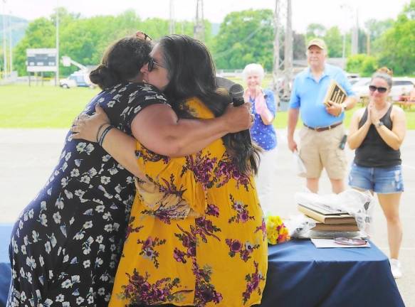 Tamara Contreras (right) gets a hug of appreciation from a tearful Christina Sanchez (Photo by Vera Olinski)