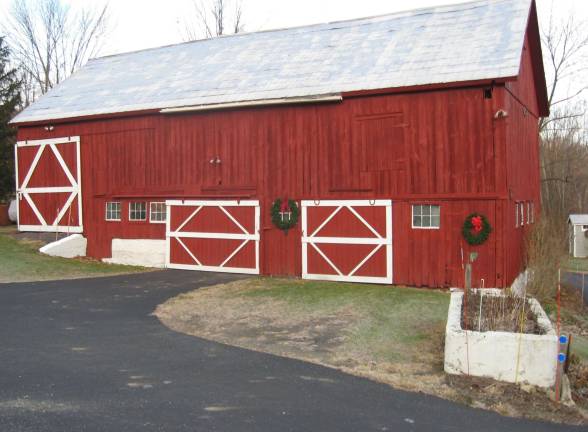 PHOTOS BY JANET REDYKE The Cedar Crest barn recently received a new coat of red paint and festive evergreen wreaths.