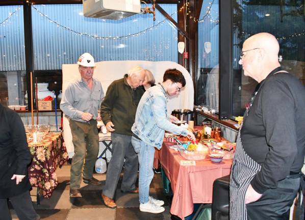 Guests get food at the Keeper’s Banquet on Saturday.