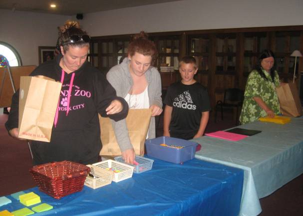 Parents and students prepare for the first day of school by choosing necessary items.