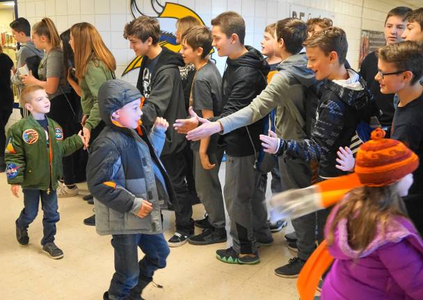 Glen Meadow eighth-grade students high-five good-bye to their guests.