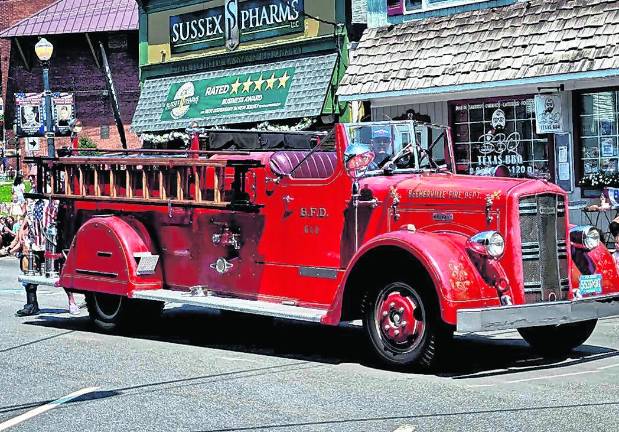 <b>A fire truck is shown in the parade.</b>