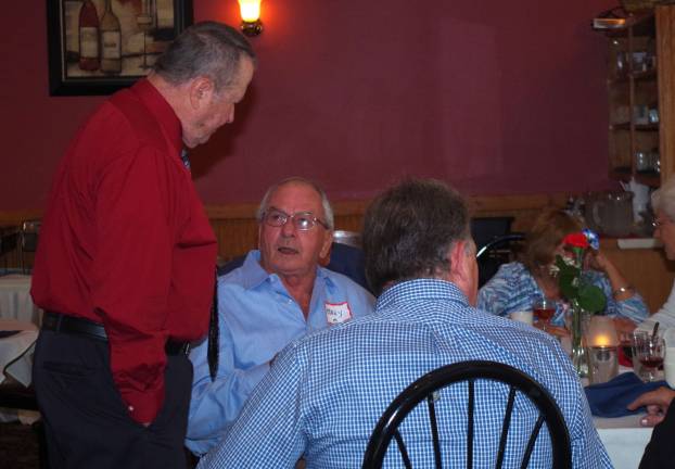 At left, former Police Chief Ken Johnson went from table to table to greet old friends and coworkers. Police Dept. marked 40 years on Oct. 3.