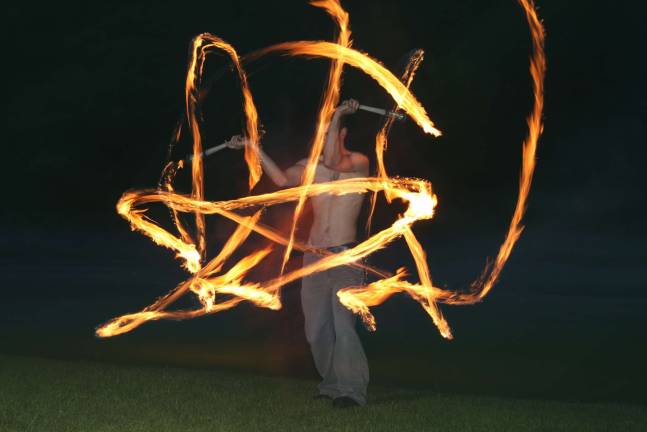 Jon Larsen shows his skills at fire spinning. Photo by Gale Miko