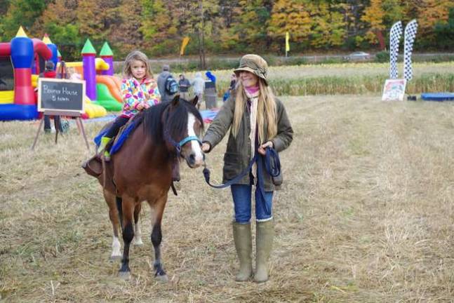 Always popular with the young boys and girls, Elizabeth Neillands of Vernon’s Pond Hollow Stables brought two ponies to the harvest festival and offered pony rides throughout the weekend. The equine shown is named “Mouse” and he previously modeled for photo shoots for Ralph Lauren.