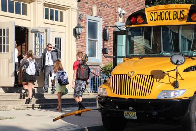 Principal Shane Schwarz welcomes students at the door.