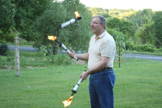 Martin Larsen juggles torches.