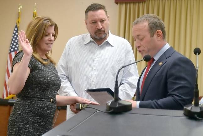 U.S. Rep. Josh Gottheimer swears in Vernon Township Councilwoman Kelly Weller as her husband, Robert, holds the bible on Jan. 1.