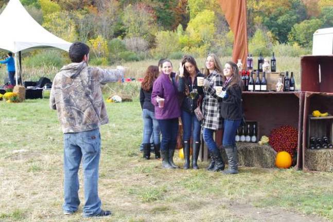 Harvest fest visitors take a photo.