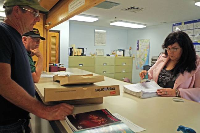 Photo by Chris Wyman Wallkill Valley Veteran of Foreign Wars Past Commander and petition chairman Bob Constantine, front, and VFW member Tom Gundlach look on while Vernon Township Clerk Lauren Kirkman certifies the post's petitions