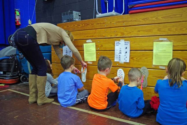 Jaime Gabriele, a parent volunteer from the Walnut Ridge School and Community Association helps teach hands-on skills about the shoe tying process via an exercise called &#x201c;Don&#x2019;t Lose Your Shoes.&#x201d; You start with a &#x201c;loop swoop pull&#x201d; and then make &#x201c;bunny ears.&#x201d;