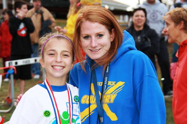 Calissa Gaechter is shown with Sussex Middle School cross-county coach Kaleigh Ralph.