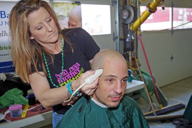 Radio personality Jim Borasio of Vernon, the morning DJ at radio station WNNJ 103.7 came in for a buzz cut. Throughout the week, he helped promote the event on his radio program. Mary Ayn Meidling of Roxbury's Nino's Expressions tried to be gentle with him.