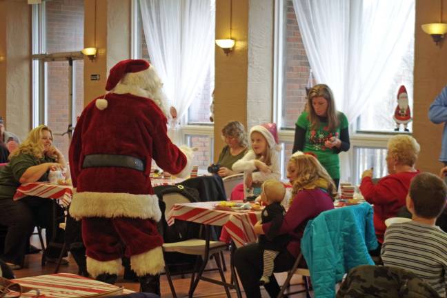Santa made the rounds from table to table in the packed Barry Lakes clubhouse.