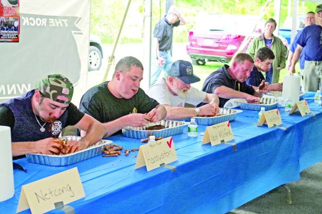 Firemen, from left, Kevin Fryer (Hardyston), Mike Bartilucci (West Milford), Stan Utter (Frankford), Jim Vandertulip (Sparta), and Kyle French (Fredon) chow down during the Sussex Franklin Auto Mall's Rib Eating Contest.