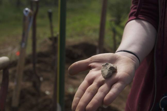 Jillian Banks of the Vernon Historical Society shows off an artifact  a crafted point  found by students from Glen Meadow Middle school on Thursday at Black Creek Site.