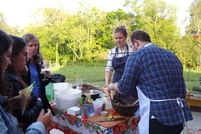 New York City chefs and culinary instructors Clare Langan and Joel Gamoran prepare appetizers for visitors at the Meadowburn Farm Autumn Harvest Dinner.